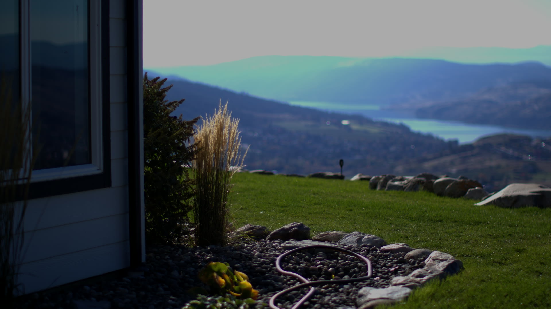 Suite Eh!'s own door, the rock garden and Kalamalka Lake