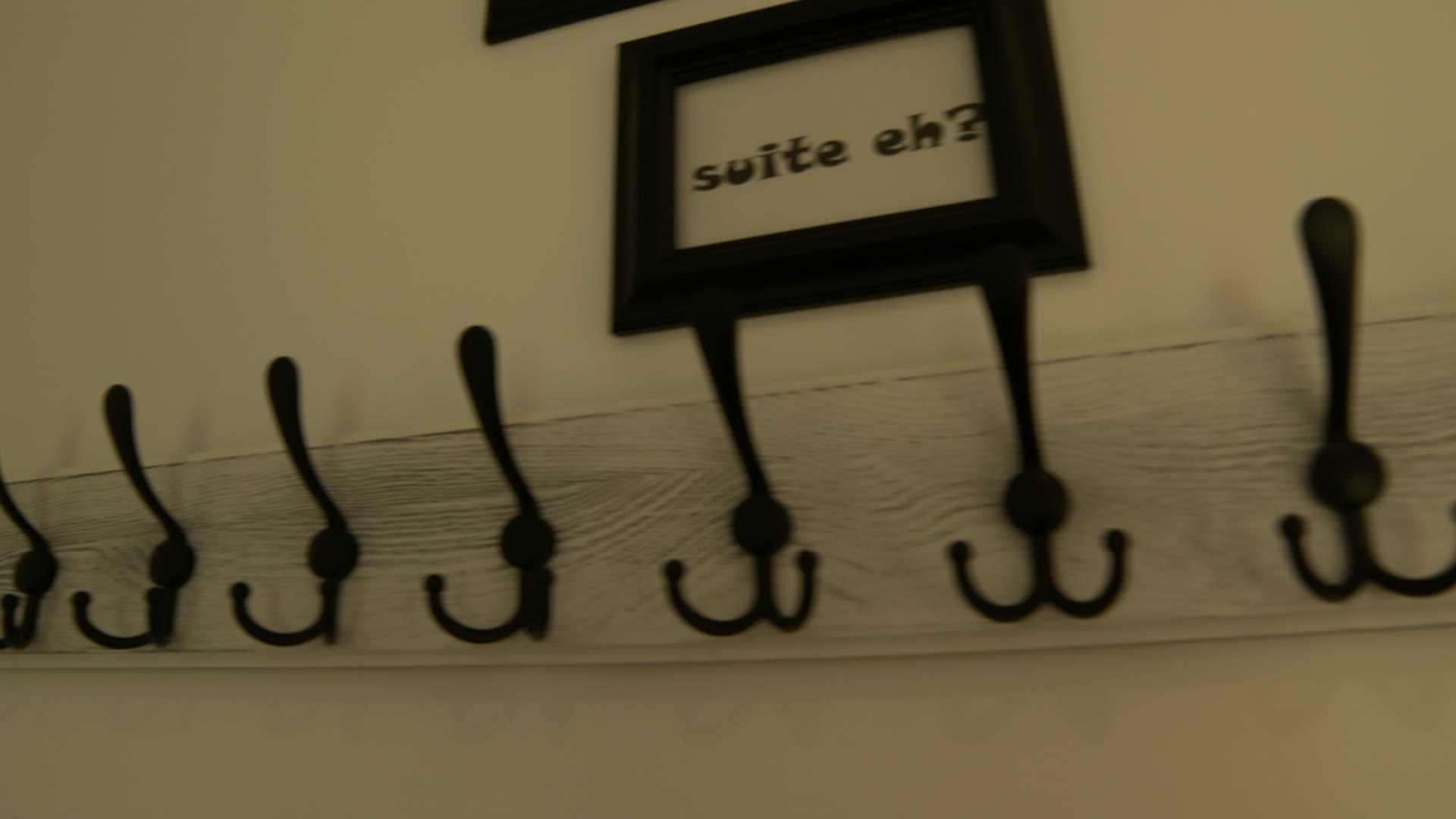 The 'suite eh?' sign over the coat hooks