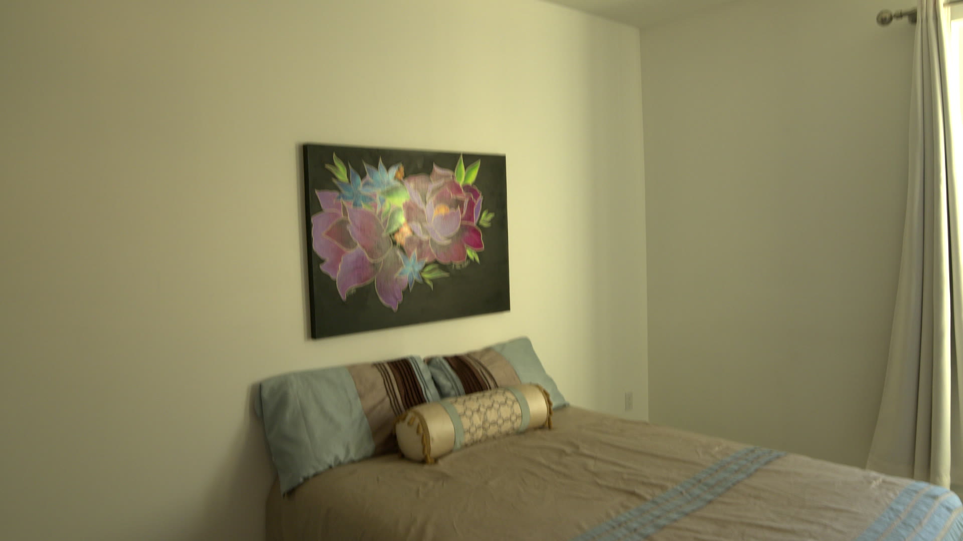 Bedroom: the bed and the floral painting